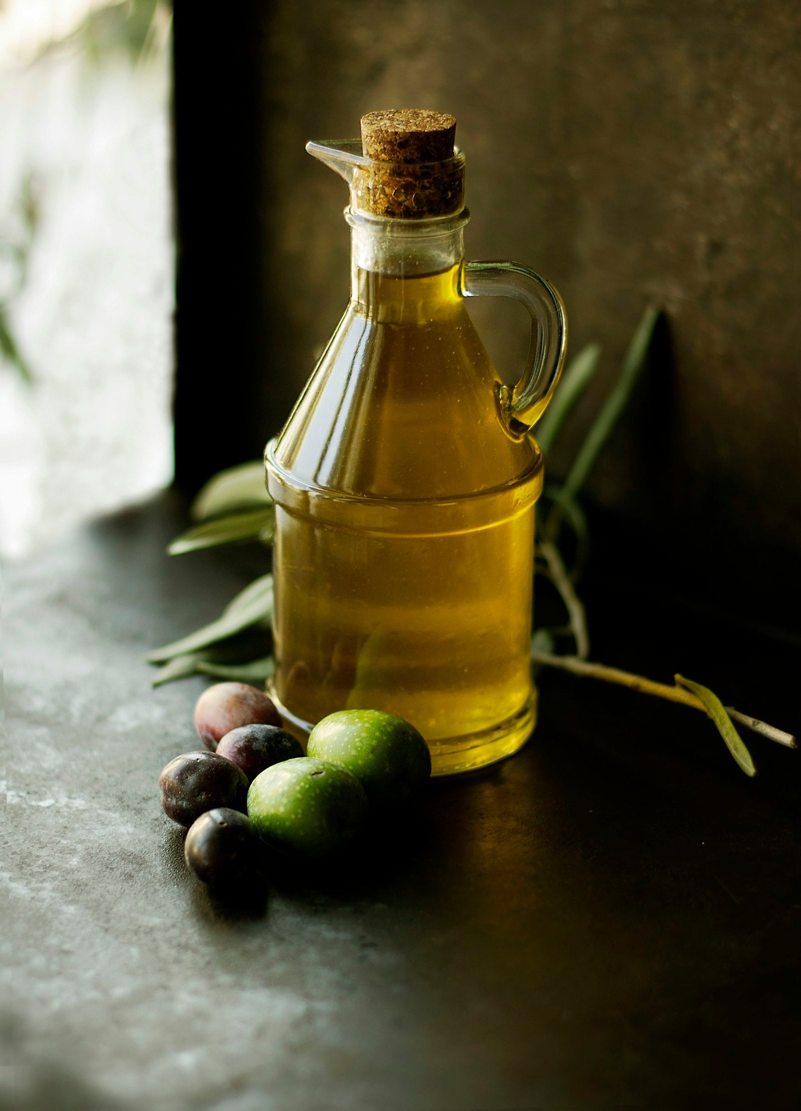 A spoon of ghee beside nuts and cooking oils in an Indian kitchen